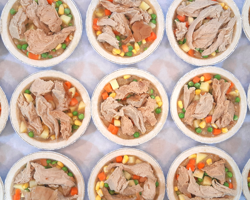A tray of Chikun Pot Pie stuffed full and waiting for their tops.